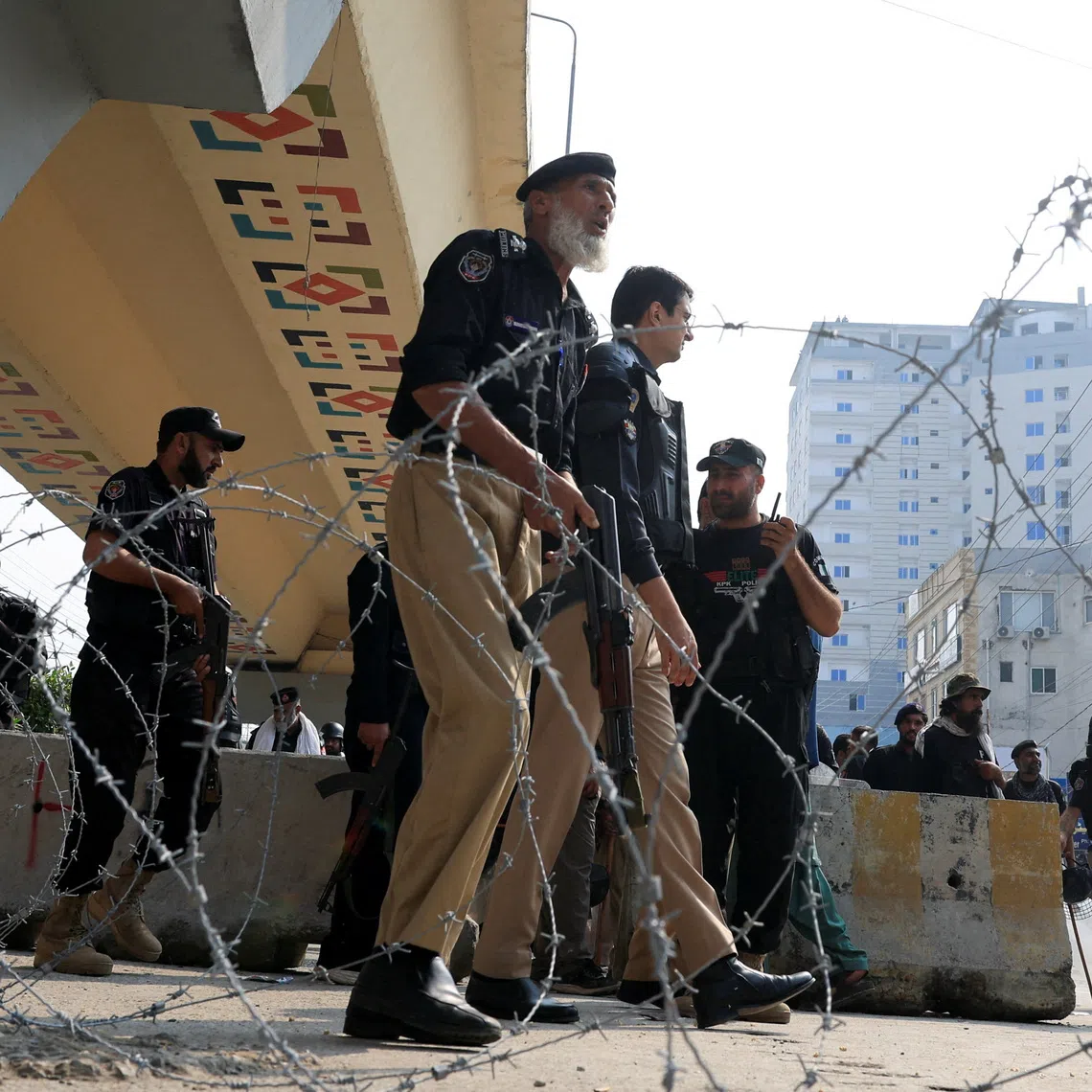Police guard a road leading to Red Zone, in Peshawar, Khyber Pakhtunkhwa province, Pakistan, on Oct 11.