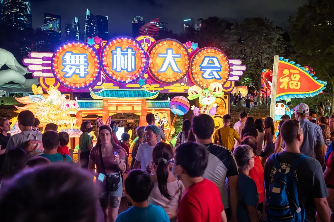 Visitors walking by the Welcome Arch lantern at River Hongbao 2023 located in Gardens By The Bay on Jan 21, 2023.