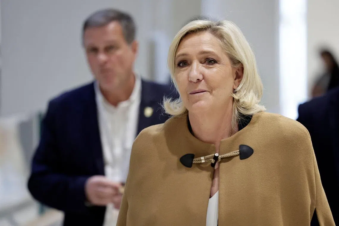 French far-right Rassemblement National (RN) Member of Parliament Marine Le Pen (R) arrives with French far-right Rassemblement National (RN) party First Vice-President and Mayor of Perpignan Louis Aliot (L) for a trial on suspicion of embezzlement of European public funds, at a court in Paris on November 5, 2024. French far-right leader Marine Le Pen went on trial on September 30, on charges of embezzling European Parliament money. Le Pen and 25 people including other National Rally (RN) party chiefs, are on trial until November 27, accused of creating fake jobs to embezzle European Parliament money. (Photo by STEPHANE DE SAKUTIN / AFP)