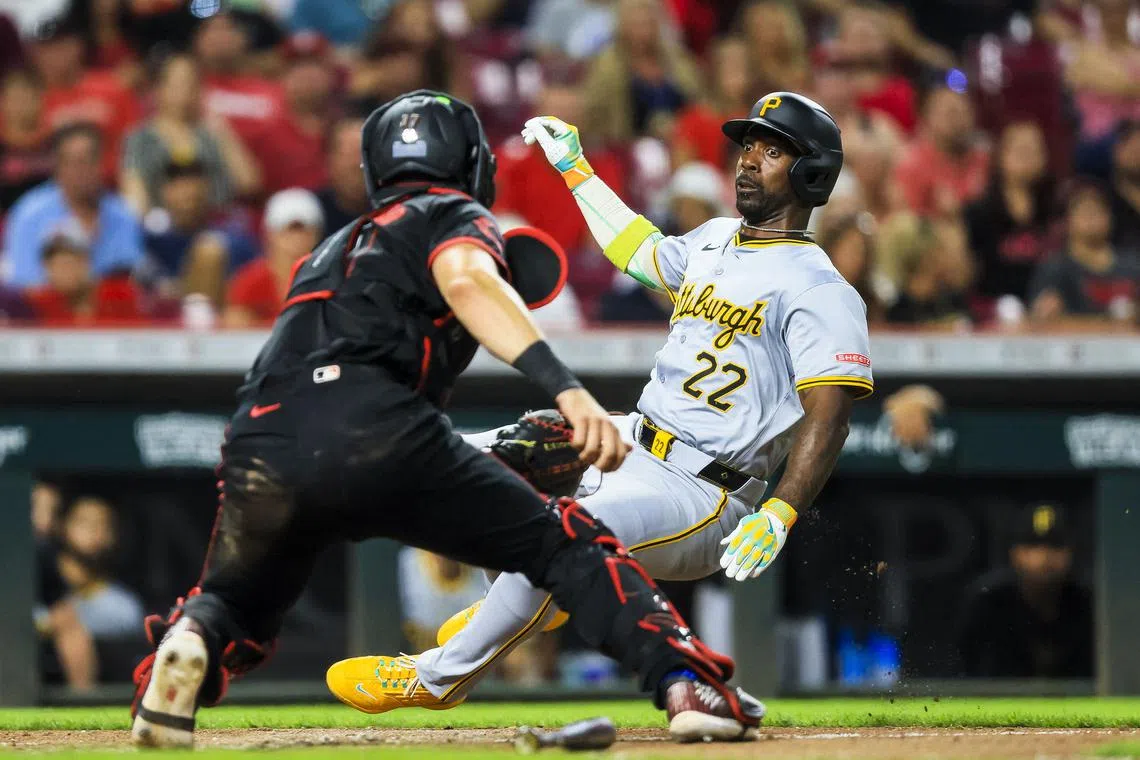 Sep 20, 2024; Cincinnati, Ohio, USA; Pittsburgh Pirates designated hitter Andrew McCutchen (22) attempts to score on a single hit by third baseman Jared Triolo (not pictured) in the seventh inning against the Cincinnati Reds at Great American Ball Park. Katie Stratman-Imagn Images/File Photo