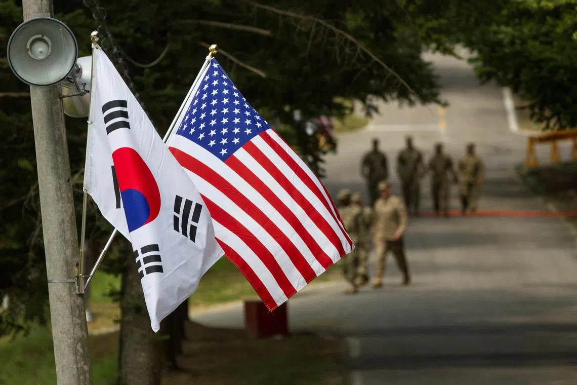 FILE PHOTO: The South Korean and American flags fly next to each other at Yongin, South Korea, August 23, 2016. Picture taken on August 23, 2016.  Courtesy Ken Scar/U.S. Army/Handout via REUTERS/File Photo