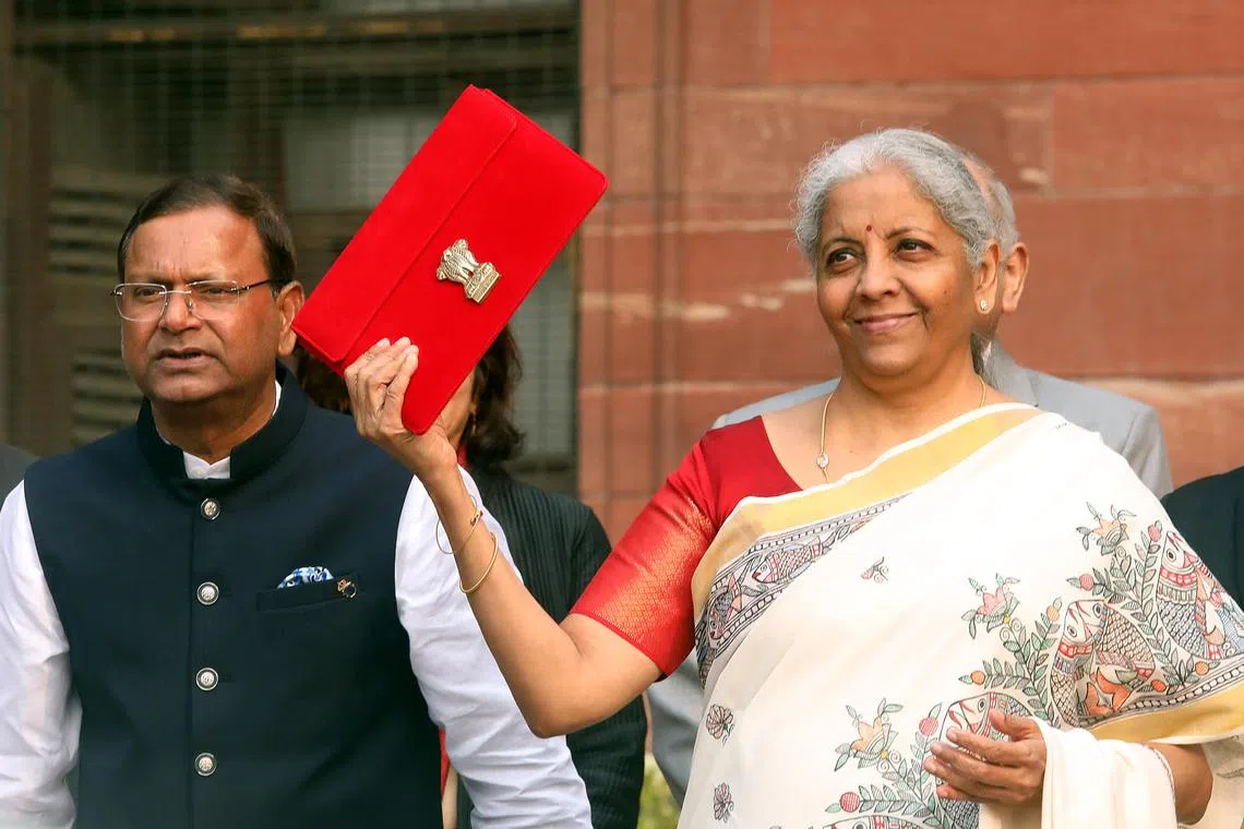 epa11867282 Indian Finance Minister Nirmala Sitharaman (R) holds a folder containing Union Budget documents outside the Ministry of Finance in New Delhi, India, 01 February 2025. The Union Budget 2025-26 will be presented in the parliament by the country's finance minister Nirmala Sitharaman.  EPA-EFE/STRINGER
