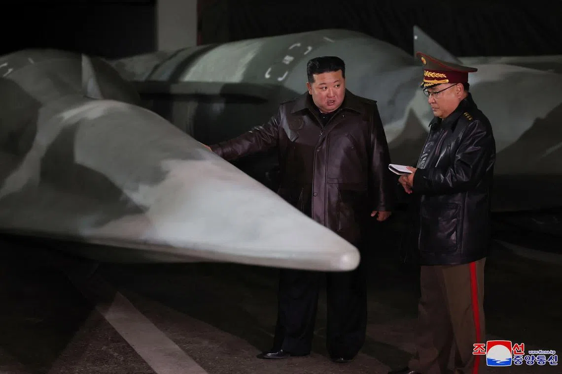 North Korea's leader Kim Jong Un (left) visiting a strategic missile base at an undisclosed location in North Korea.  