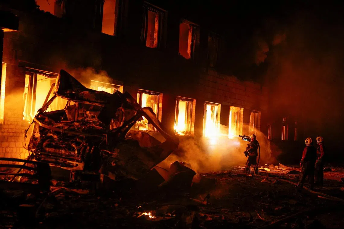 Firefighters work at a compound of a private enterprise damaged during Russian missile strikes, amid Russia's attack on Ukraine, in Kyiv, Ukraine July 16, 2026. REUTERS/Valentyn Ogirenko