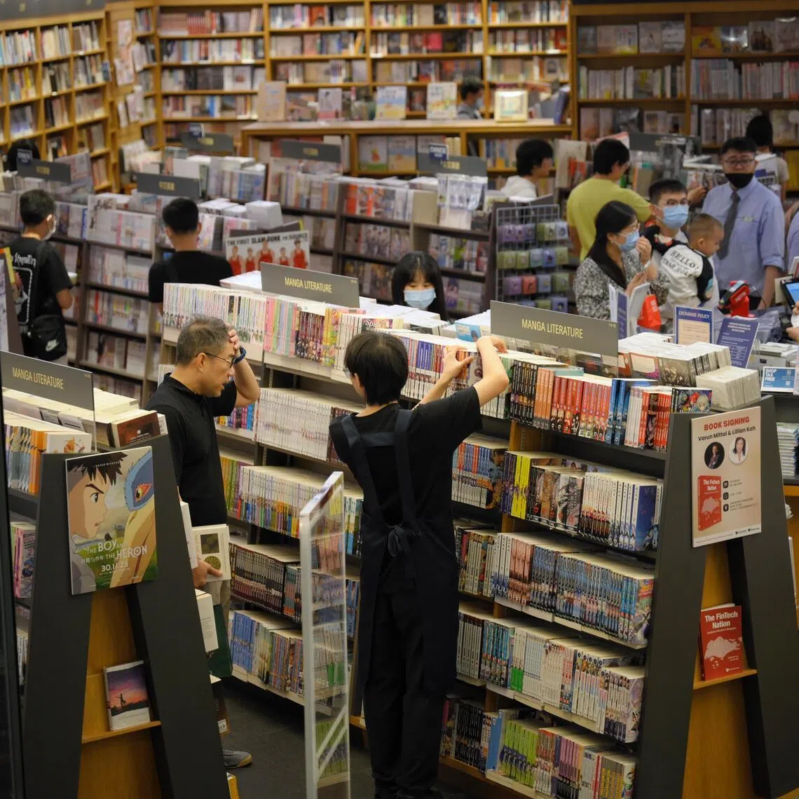 People browsing books at Books Kinokuniya in Orchard, 23 December 2023.