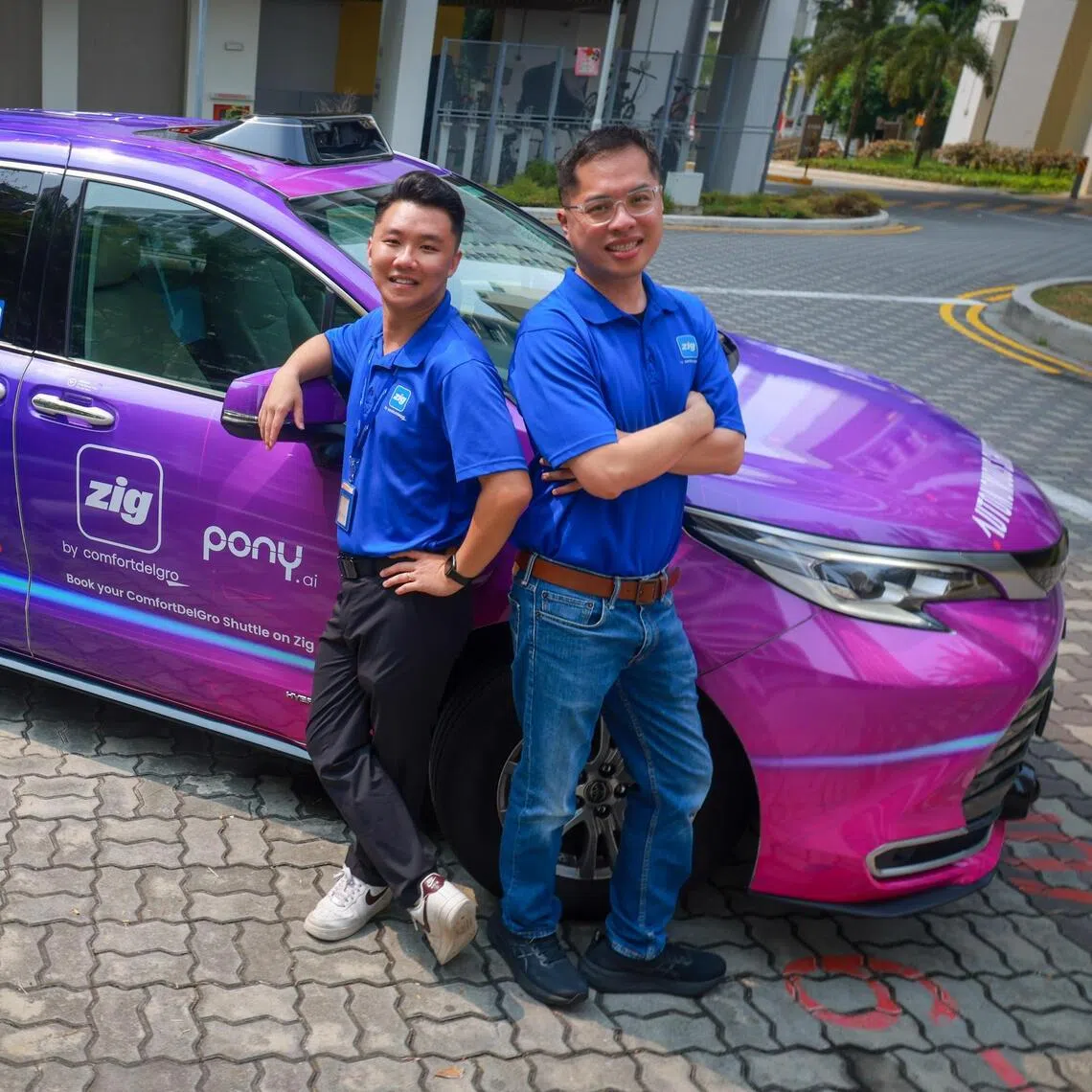 Sherman Seng (left), a safety operator of autonomous vehicles for Zig Driverless and fleet manager William Tan.