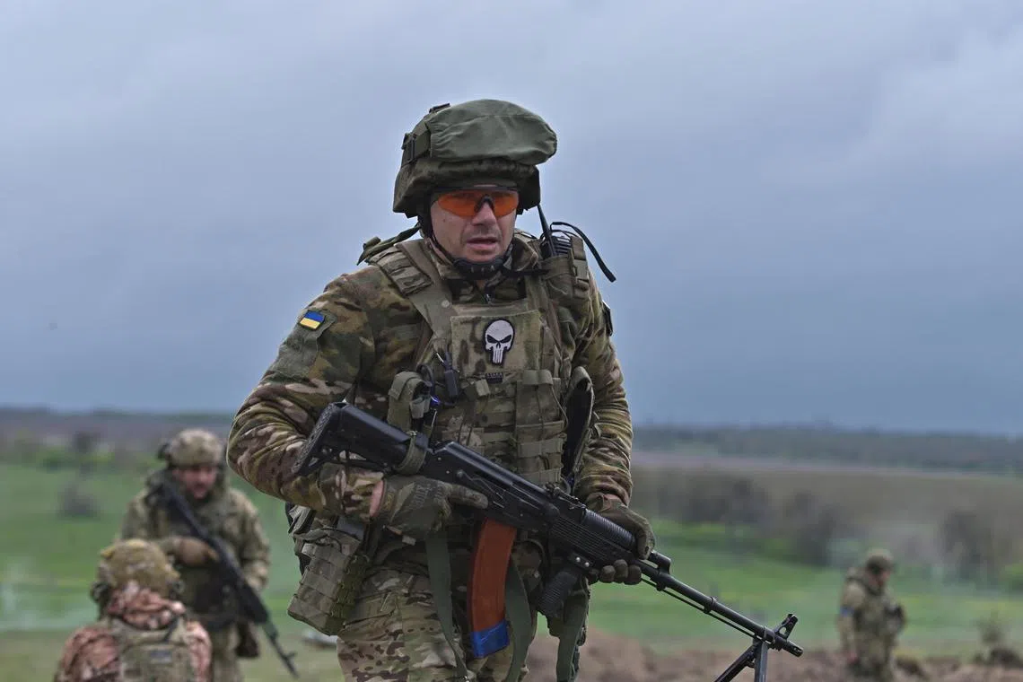 A Ukrainian serviceman attends a military drill at a training ground in Ukraine's Zaporizhzhia region.