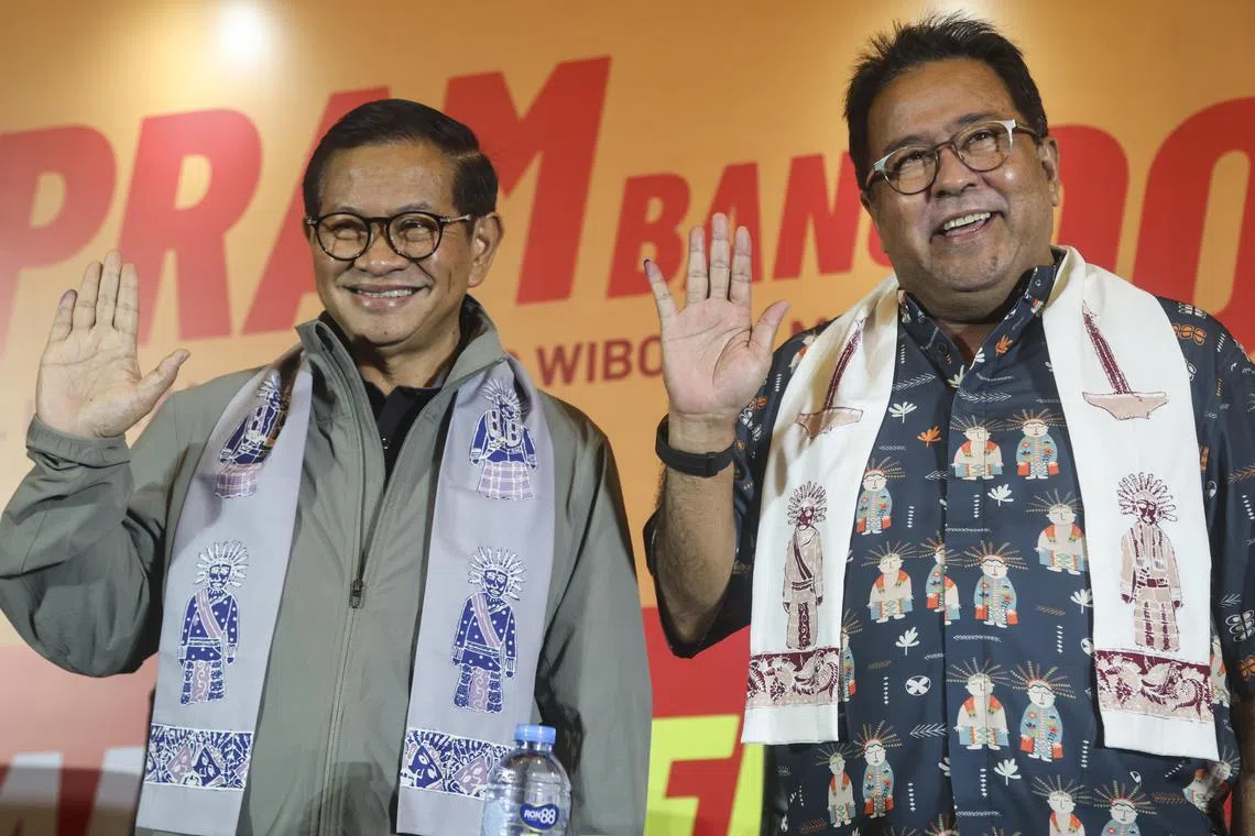 Mr Pramono Anung (left) and his vice governor candidate Rano Karno (right) wave to journalists at a press conference during the regional government elections in Jakarta, on Nov 27, 2024.