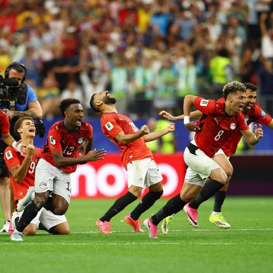 Soccer Football - FIFA World Cup 2026 - Round of 32 - Australia v Egypt - Dallas Stadium, Arlington, Texas, U.S. - July 3, 2026
Egypt players celebrate after Hossam Abdelmaguid scores the penalty past Australia's Mathew Ryan to win the shoot-out as Egypt qualify for the Round of 16 stage of the World Cup REUTERS/Hannah Mckay     TPX IMAGES OF THE DAY