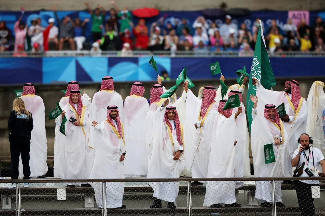 Paris 2024 Olympics - Opening Ceremony - Paris, France - July 26, 2024. Athletes of Saudi Arabia are seen aboard a boat in the floating parade on the river Seine during the opening ceremony. REUTERS/Kim Hong-Ji