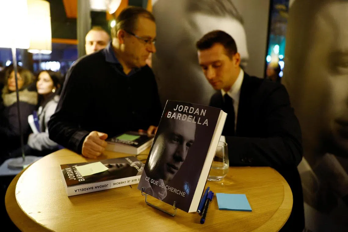 Mr Bardella is surrounded by supporters as he signs his book  What I'm looking for in Paris, France.