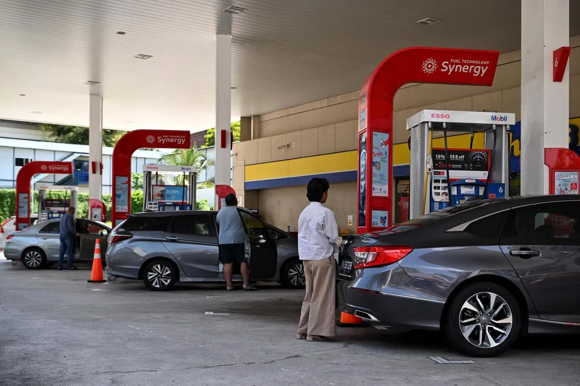 First to cut prices again: An Esso petrol station along Bukit Timah Road.