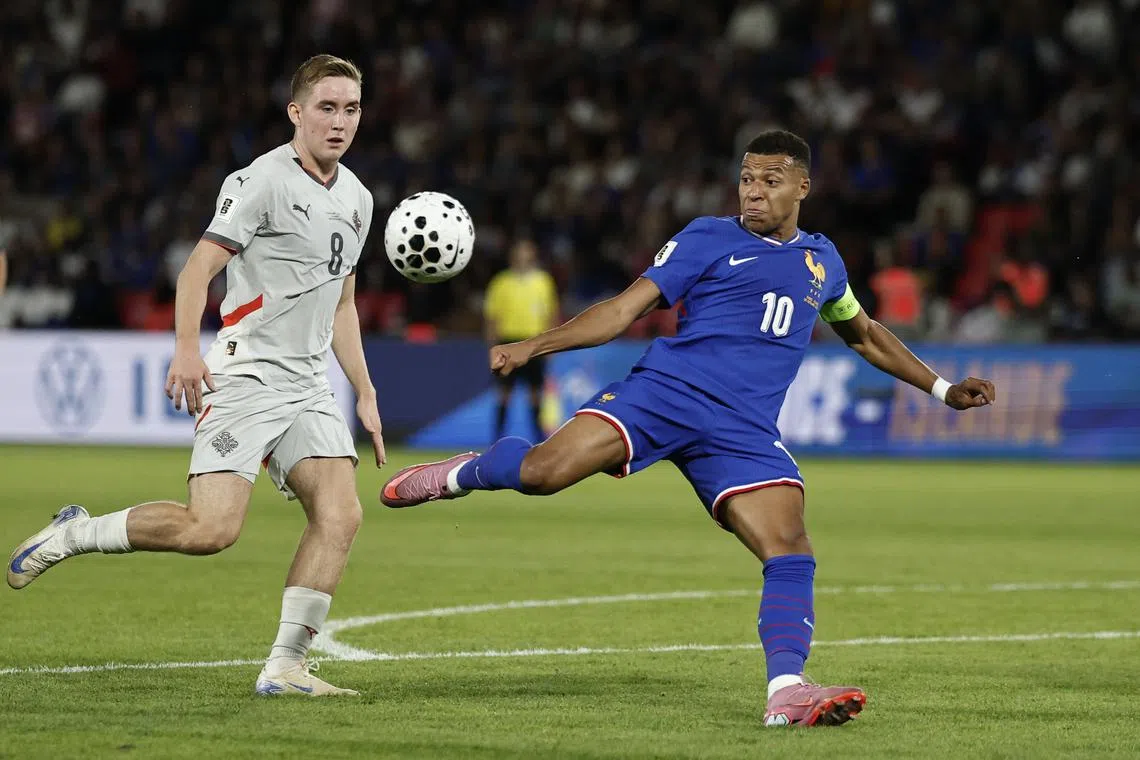 Soccer Football - World Cup - UEFA Qualifiers - Group D - France v Iceland - Parc des Princes, Paris, France - September 9, 2025 France's Kylian Mbappe in action with Iceland's Isak Johannesson REUTERS/Benoit Tessier