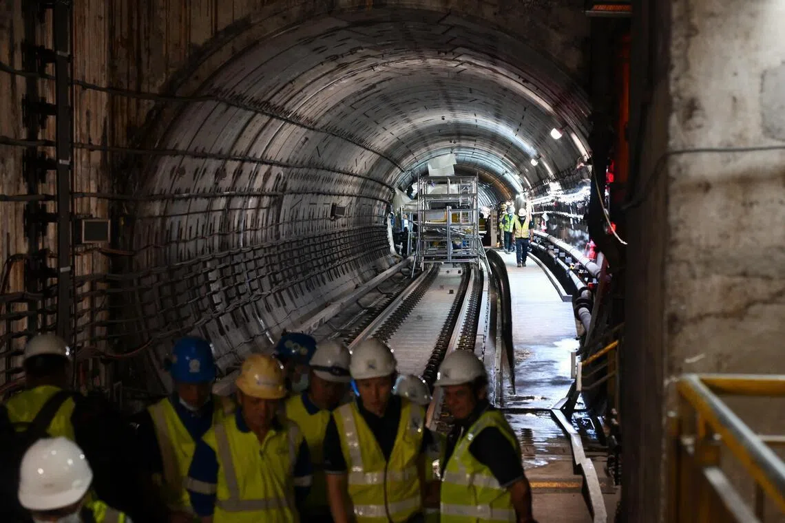 Workers seen during a media tour of one of the tunnels, at the Dakota MRT station, on Feb 9, 2026.