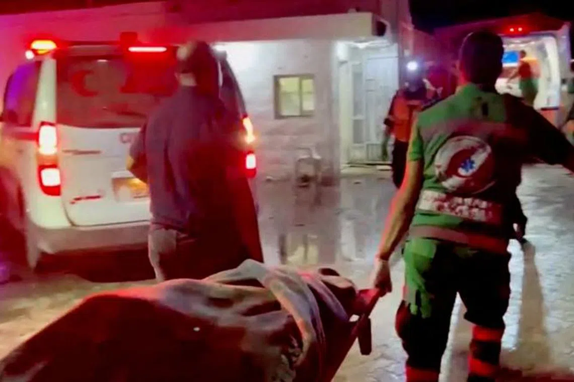 Rescue personnel work at scene At Al-Ahli Hospital, after hundreds of Palestinians were killed in a blast at Al-Ahli hospital in Gaza that Israeli and Palestinian officials blamed on each other in Gaza City, Gaza Strip, in this screen grab obtained from video, October 17, 2023.  REUTERS/Reuters TV