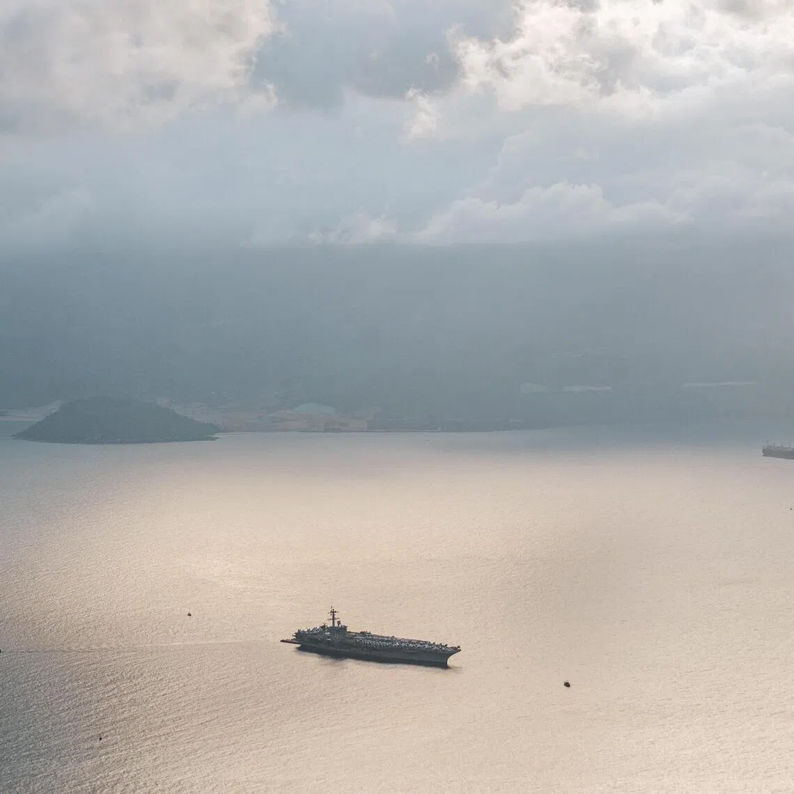 NYTSELECTS — The aircraft carrier USS George Washington arrives in Da Nang, Vietnam, for a seven-day port call on Thursday, July 30, 2026. The visit, the longest since the two countries restored relations, is a show of mutual cooperation and a signal from the U.S. to China. But it comes during tensions over tariffs. (Linh Pham/The New York Times)
