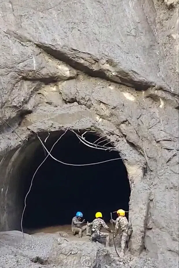Members of the Nepali Army rescue a person trapped inside a tunnel at a hydropower project in Nepal’s Rasuwa district, in a screengrab from video.