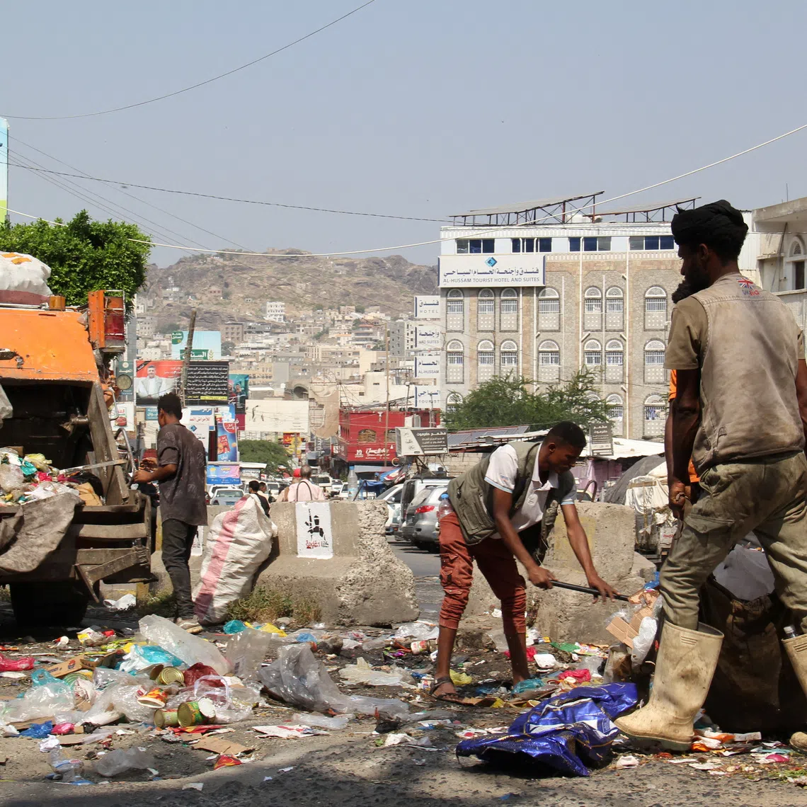 Workers collect garbage from a street in the southwestern city of Taiz, Yemen, October 20, 2026. REUTERS/Anees Mahyoub