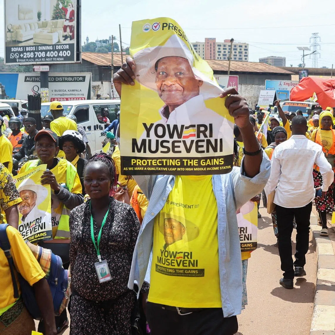 Supporters of Uganda's president Yoweri Museveni march along the street on Jan 13, ahead of an election in which he will stand for a seventh term.