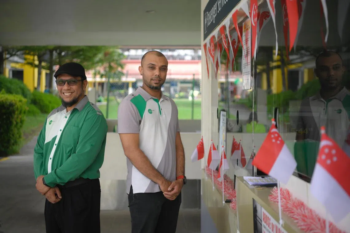 Muhamad Nasran Jafar (left), a Tower Transit Singapore bus driver, and Naveen Ruthven, an interchange supervisor, pictured at Sembawang Bus Interchange on August 23, 2023. They were given the Singapore Civil Defence Force’s Community First Responder Award on Aug 17, 2023, for performing cardiopulmonary resuscitation (CPR) on an elderly Chinese man who was found motionless in a public toilet at Sembawang Bus Interchange in January. 