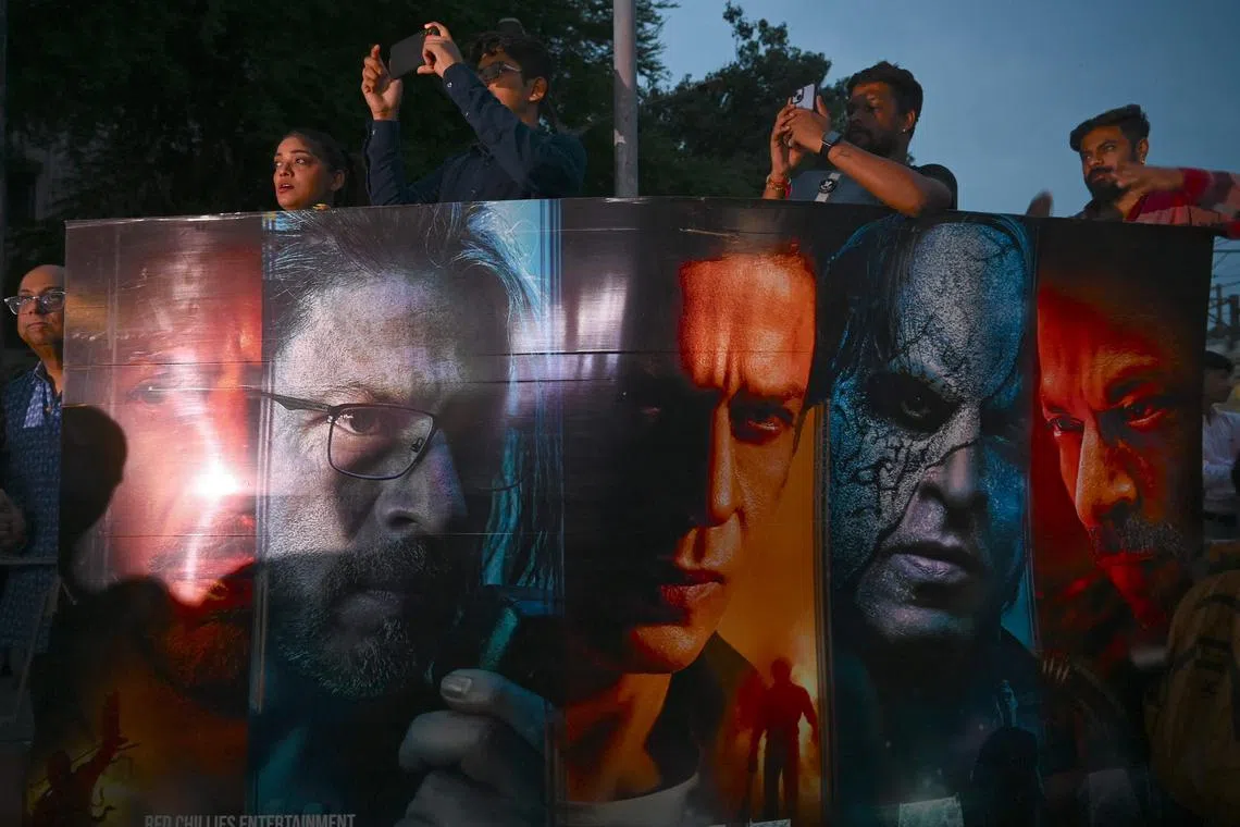 Fans of Indian actor Shahrukh Khan wait outside a movie theatre to watch the first show of Khan’s latest Bollywood film - Jawan, in Mumbai on Sept 7, 2023. 