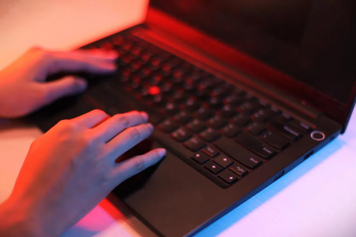 CMG20240627-HengYY01 / 王彦燕 / 犯罪示意图 ：Crime: Cyber crime concept. [SPH] Theif steals money. Business / Man holding money dollars in hand in black gloves.Hacking concept with hand wearing black leather glove. Computer keyboard with hands in black gloves.Data theft stock photo.Hacker hand in glove.Thief stealing data from a laptop.、scam、Online scam, scams, frauds, scammers, phishing, e-commerce scams 、phone scam、work scam 、Singapore dollars、滥用电脑、欺诈、意图、网络、科技犯罪、黑客、诈骗、新币