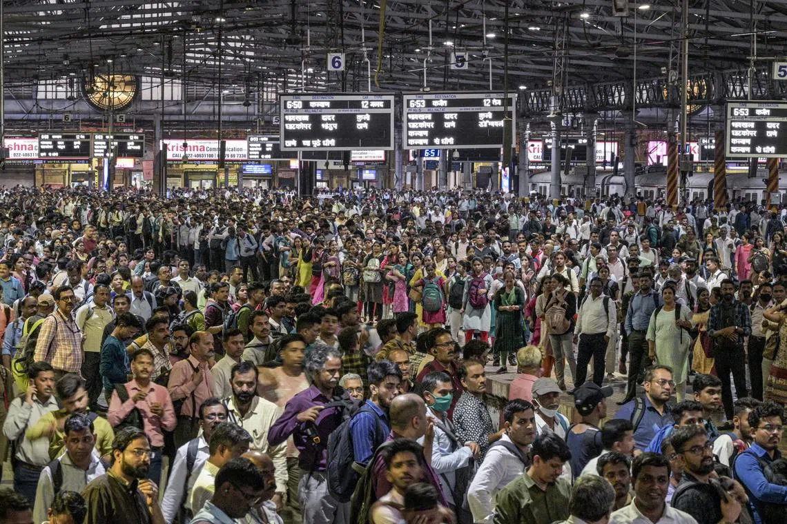 Daily commuters wait for the suburban train on the platform of CST station in Mumbai, on April 17, 2023. 