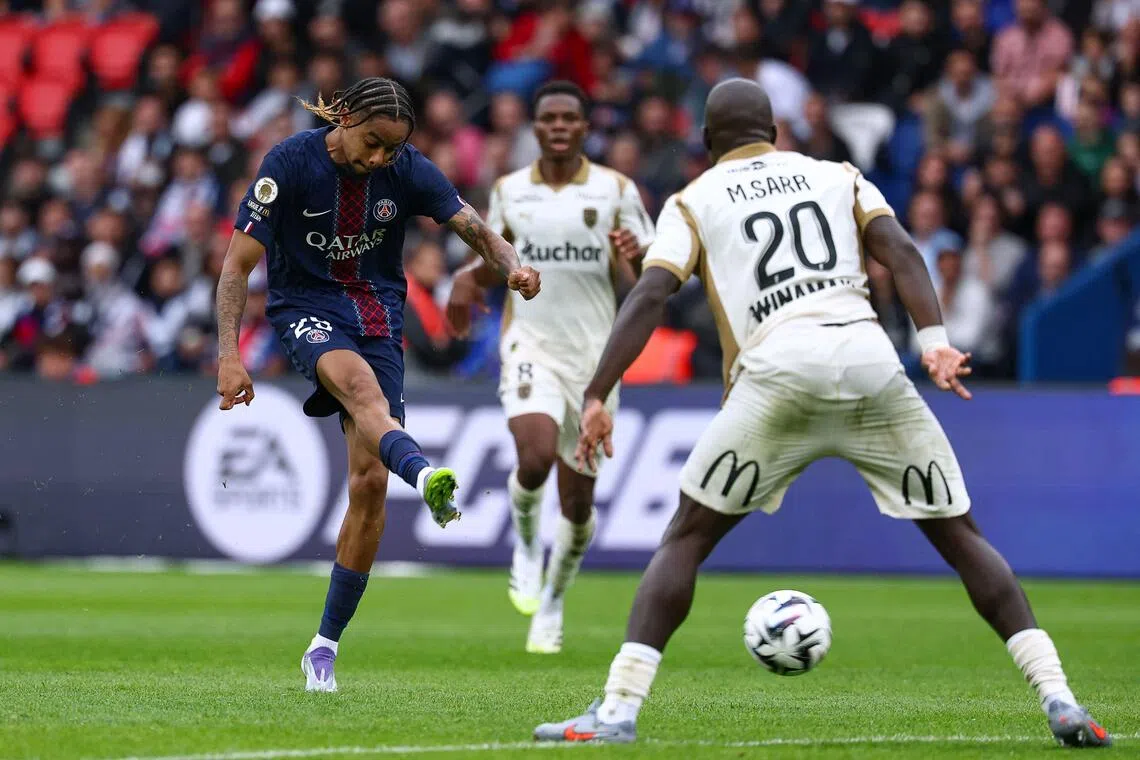 Paris Saint-Germain's French forward  Bradley Barcola shooting to score his team's second goal in the French Ligue 1 football match against Lens at the Parc des Princes on Sept 14, 2025.