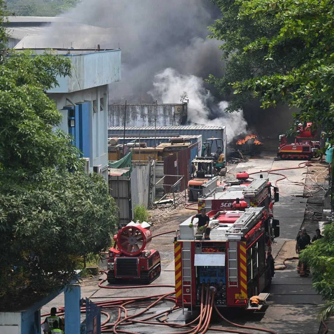 SCDF firefighters working to put out the fire at a warehouse at 10 Penjuru Road on Sept 8.