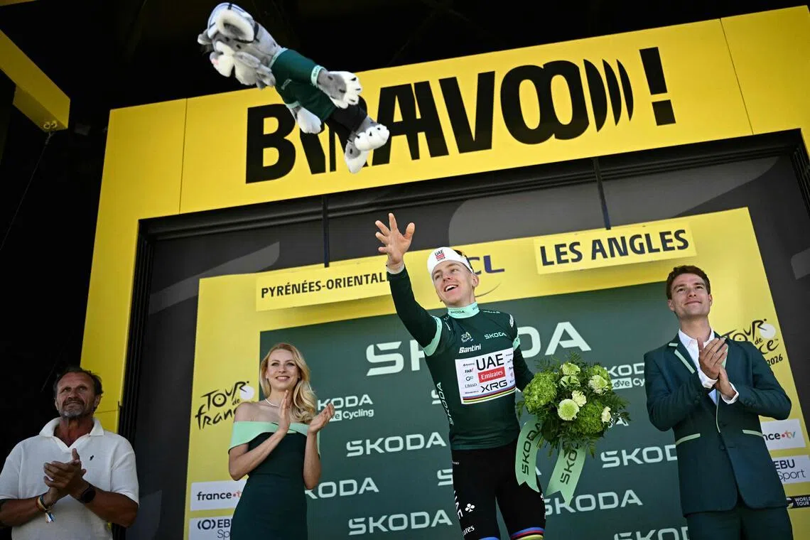 UAE Team Emirates - XRG's Slovenian rider Tadej Pogacar celebrates on the podium with the best sprinter's green jersey after the 3rd stage of the 113th edition of the Tour de France cycling race, 196 km between Granollers and Les Angles in southern France, on July 6, 2026. (Photo by Loic VENANCE / AFP)