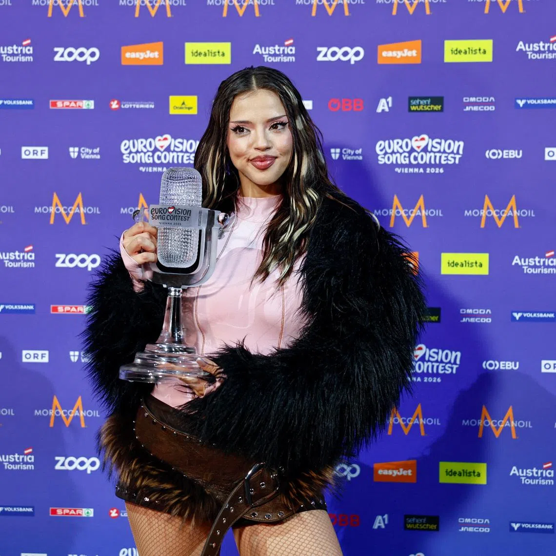 The winner of the 2026 Eurovision Song Contest, DARA, representing Bulgaria, holds the trophy at a press conference after the Grand Final, in Vienna, Austria, May 17, 2026. REUTERS/Lisa Leutner
