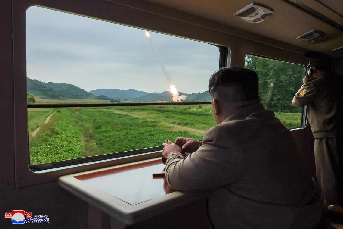 FILE PHOTO: North Korean leader Kim Jong Un oversees a test-fire for a new 600mm multiple rocket launcher at an undisclosed location in North Korea, in this photo released by North Korea's official Korean Central News Agency September 13, 2024.    KCNA via REUTERS/File Photo