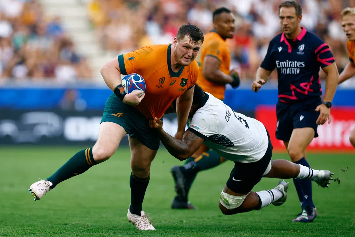 Rugby Union - Rugby World Cup 2023 - Pool C - Australia v Fiji - Stade Geoffroy-Guichard, Saint-Etienne, France - September 17, 2023  Australia's Angus Bell in action with Fiji's Te Ahiwaru Cirikidaveta REUTERS/Sarah Meyssonnier