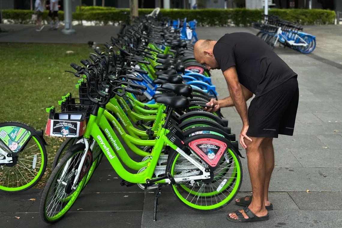 Anywheel (green) and Hello Ride (blue) bike-sharing bicycles at the Promontory at Marina Bay, March 27, 2025.