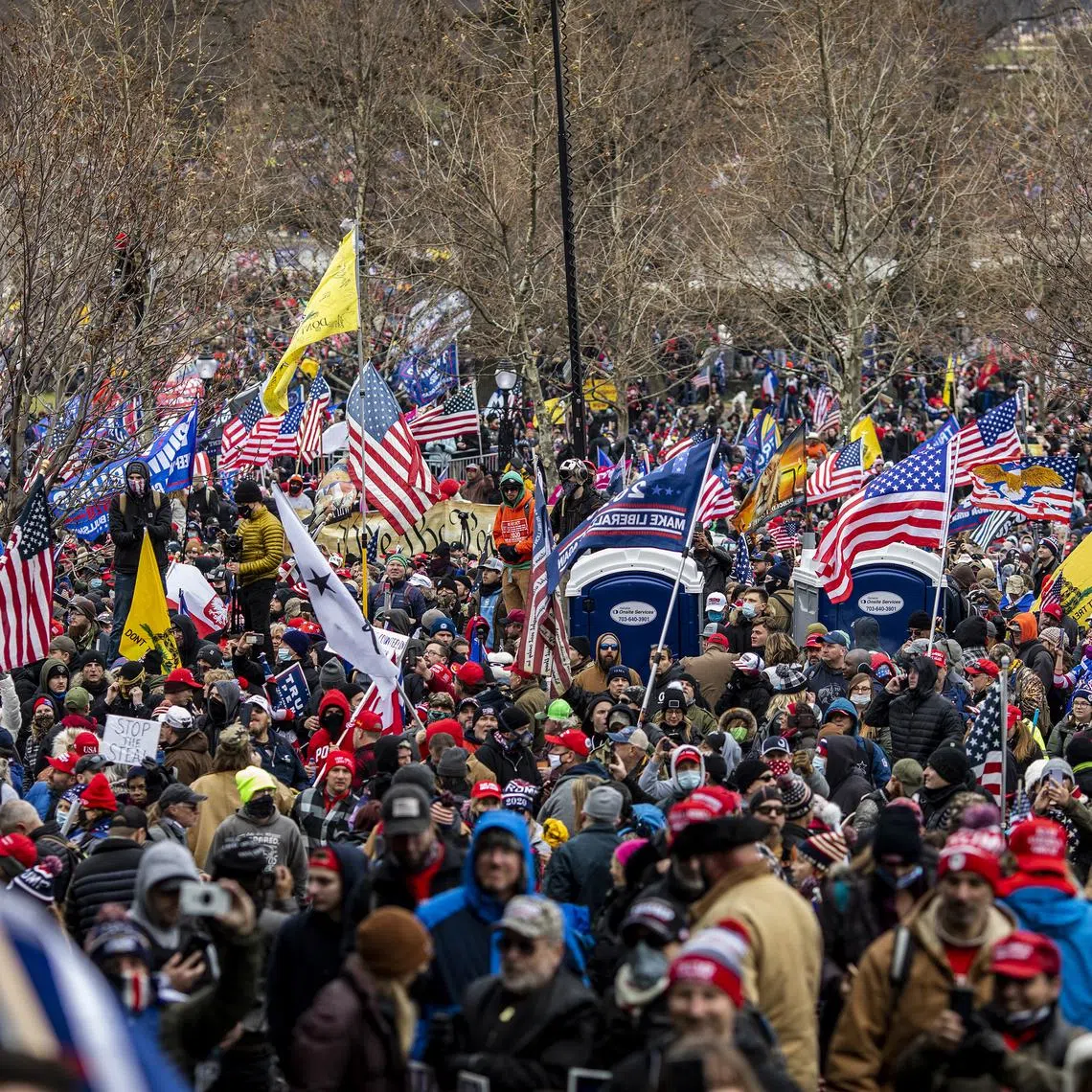 Protesters surround the U.S. Capitol after a rally at which then-President Donald Trump spoke, in Washington, on Jan 6, 2021.