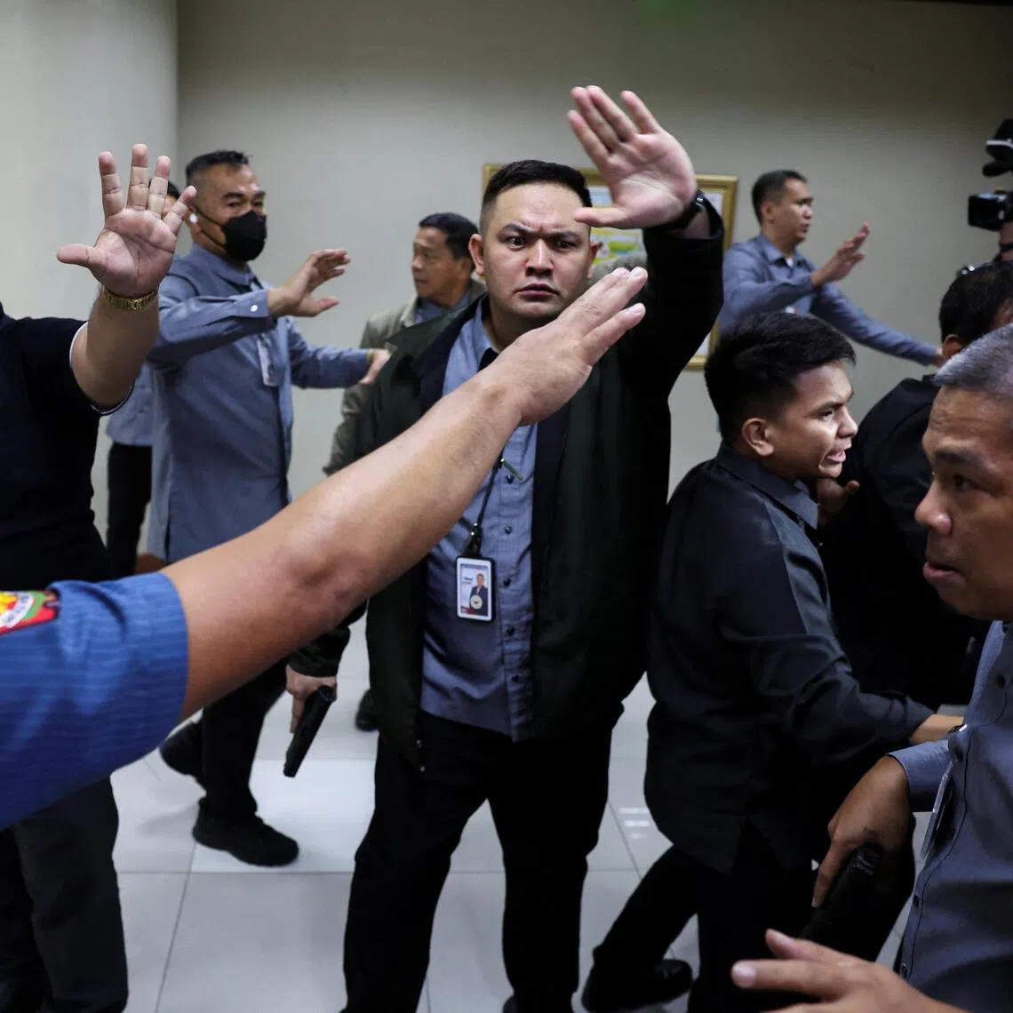 Senate security personnel and police officers ask members of the media to stay back after gunshots were heard at the Philippine Senate, as chaos mounted in anticipation of an attempt to arrest a top senator wanted by the International Criminal Court, in Pasay City, Metro Manila, Philippines, May 13, 2026. REUTERS/Eloisa Lopez
