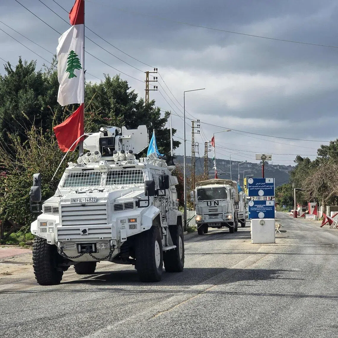 Peacekeepers with the UN Interim Force in Lebanon (UNIFIL) drive past a Lebanese army outpost in Naqura, southern Lebanon, on March 27.