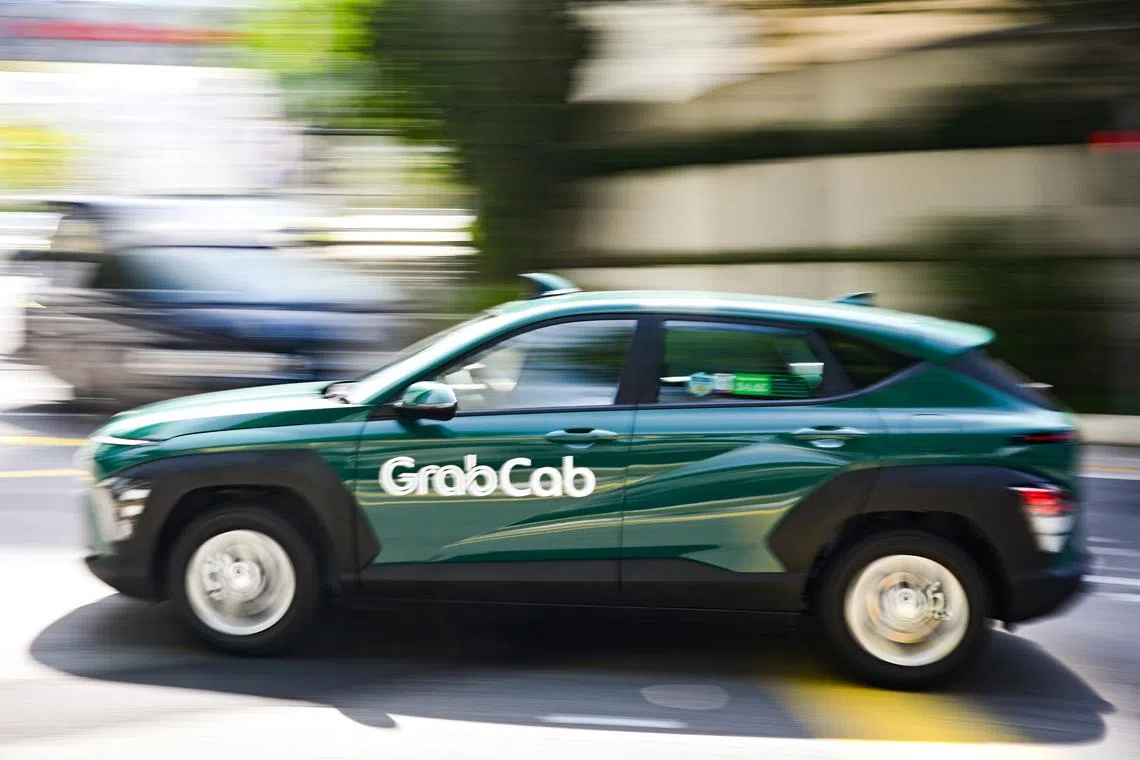 ST20260126-202688000532-Lim Yaohui-pixgeneric/ Generic photograph of GrabCab travelling along Irrawaddy Road on Jan 26, 2026. GrabCab was launched on July 2, 2025 with a flag-off ceremony at Grab’s headquarters in one-north. The taxi operator, a subsidiary of Grab’s rental arm GrabRentals, announced its entry into the market on June 4, 2025, with 40 new fifth-generation electric hybrid Toyota Prius cars. Under the terms of its street-hail operator licence, GrabCab has three years to progressively expand its fleet to meet the minimum fleet size requirement of 800 cabs. (ST PHOTO: LIM YAOHUI)