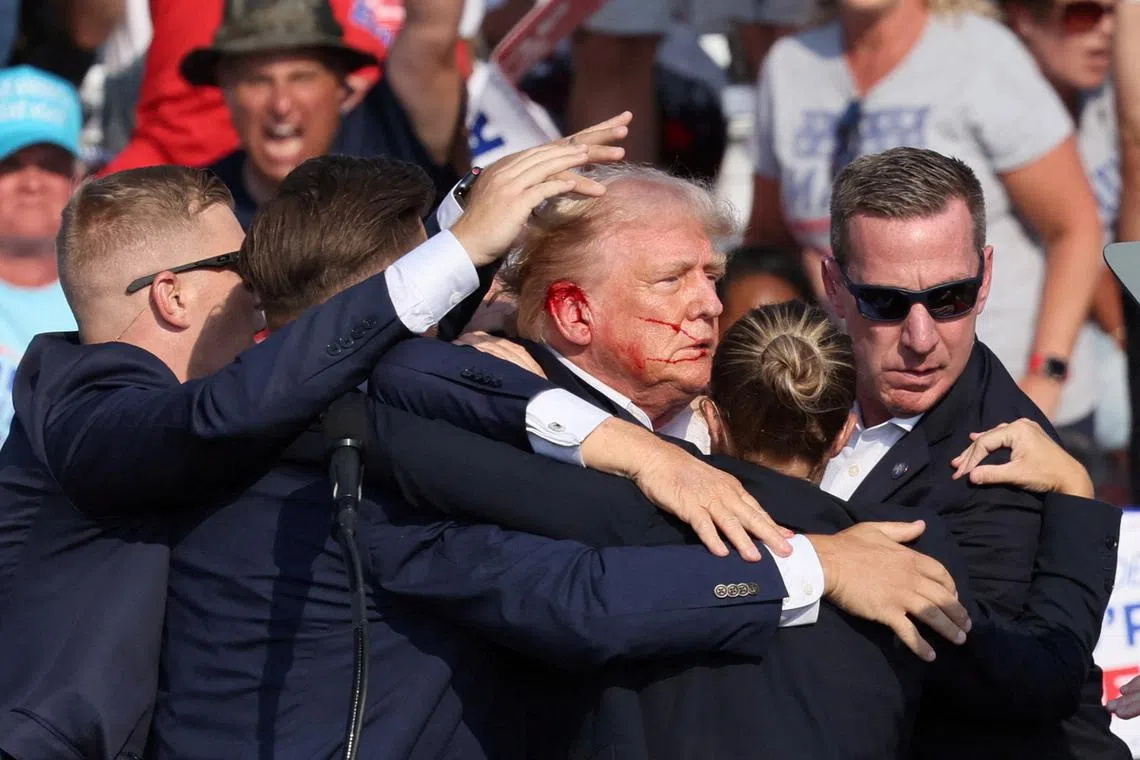 FILE PHOTO: Republican presidential candidate and former U.S. President Donald Trump is assisted by the Secret Service after gunfire rang out during a campaign rally at the Butler Farm Show in Butler, Pennsylvania, U.S., July 13, 2024. REUTERS/Brendan McDermid/File Photo