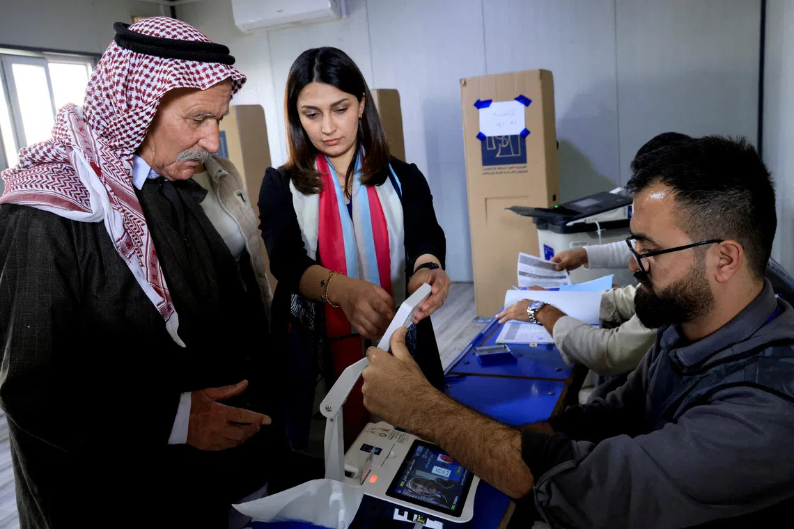 A displaced man from the Yazidi minority votes during special voting, two days before polls open to the public in Iraq.