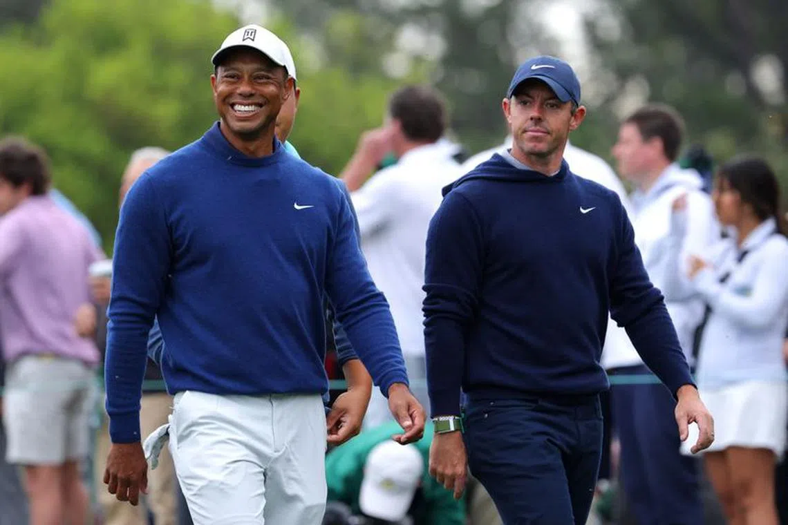 FILE PHOTO: Golf - The Masters - Augusta National Golf Club - Augusta, Georgia, U.S. - April 3, 2023 Tiger Woods of the U.S. and Northern Ireland's Rory McIlroy on the 10th during a practice round REUTERS/Brian Snyder/File Photo