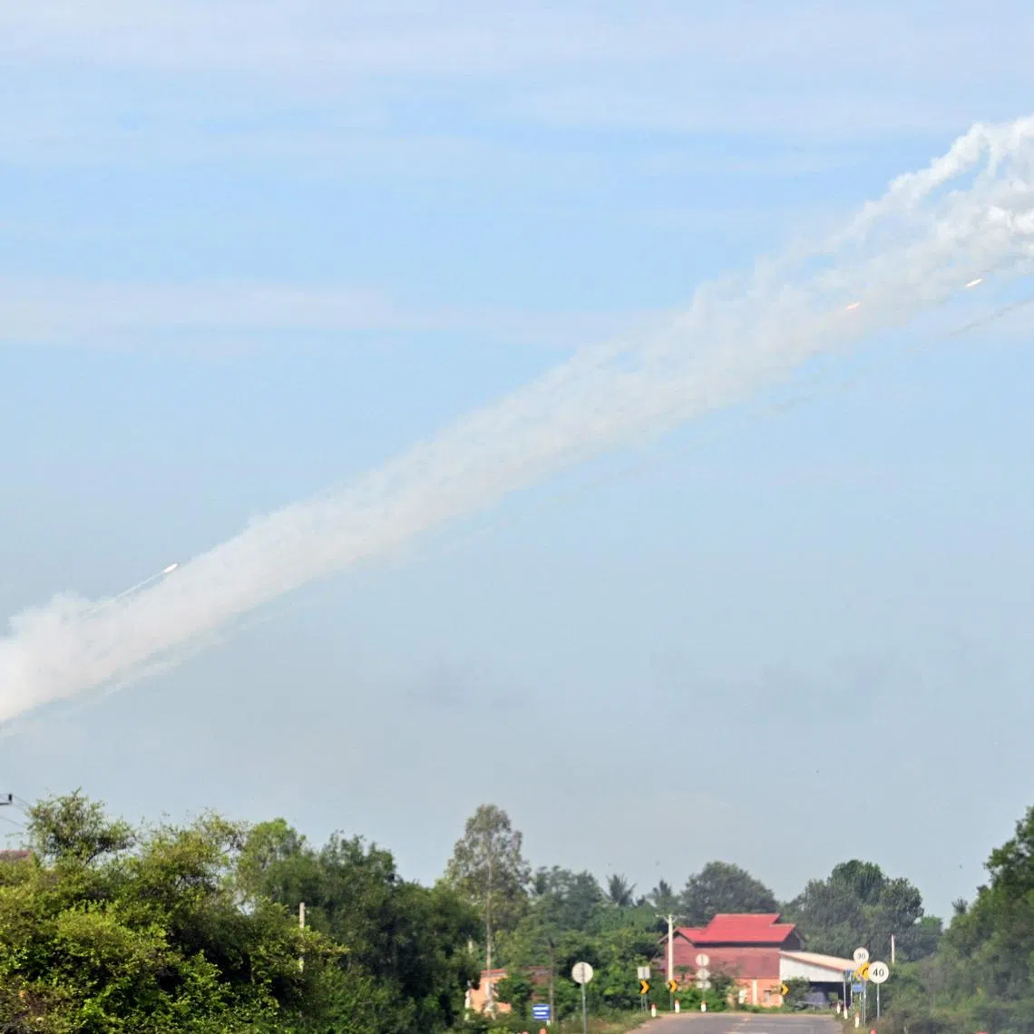 Smoke is pictured in the air as a multi-rocket launcher is fired near the Cambodia-Thailand border in Oddar Meanchey province, on July 25.