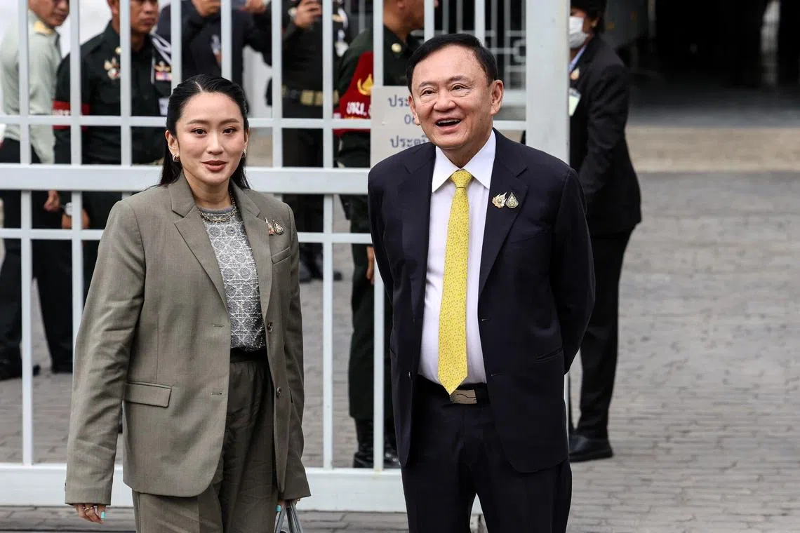 Thailand's former prime minister Thaksin Shinawatra (right) and his daughter Paetongtarn Shinawatra  arrive at the Supreme Court in Bangkok, Thailand.