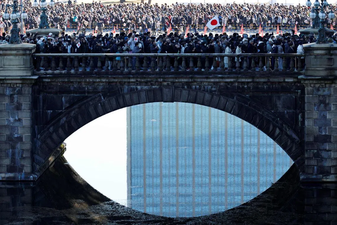 People queue up to enter the palace grounds to attend the Emperor's traditional New Year's greetings at the Imperial Palace in Tokyo on Jan 2, 2025. 