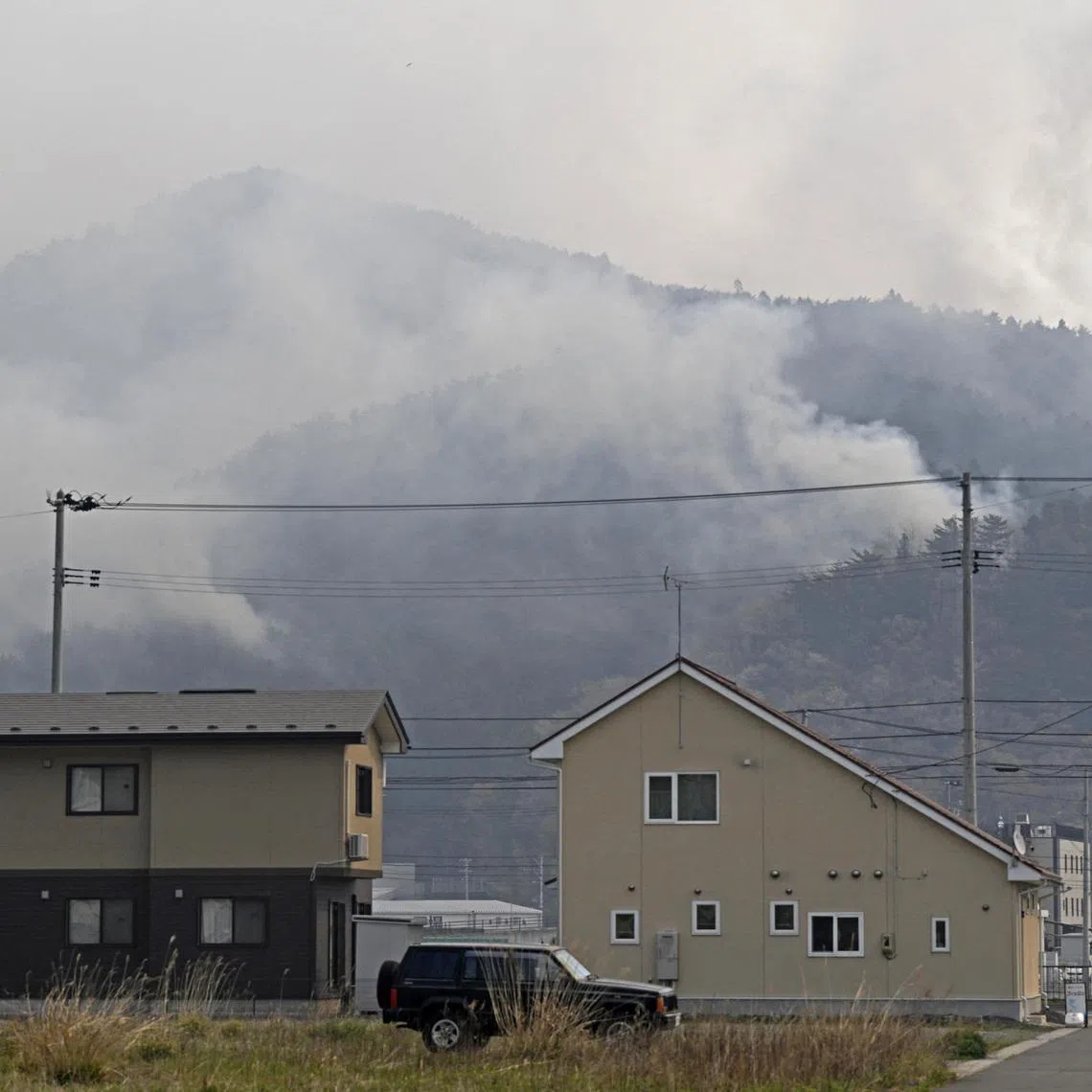 Smoke blankets mountainous areas of Otsuchi in Iwate Prefecture, Japan, on April 24, 2026, as wildfires continue, following their outbreak at two locations in northeastern Japan two days ago, in this photo taken by Kyodo. Mandatory credit Kyodo/via REUTERS
