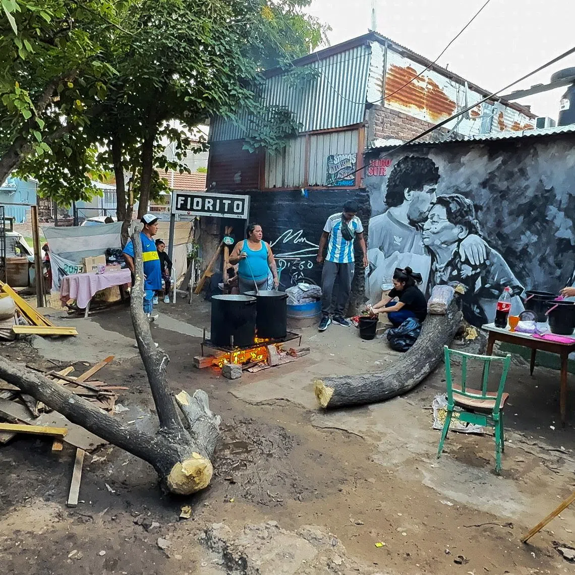 People cook stew for residents of the working-class neighbourhood of Villa Fiorito at a soup kitchen set up in the house where late soccer legend Diego Armando Maradona spent his early childhood, on the outskirts of Buenos Aires, Argentina, March 26, 2026. REUTERS/Miguel Lo Bianco