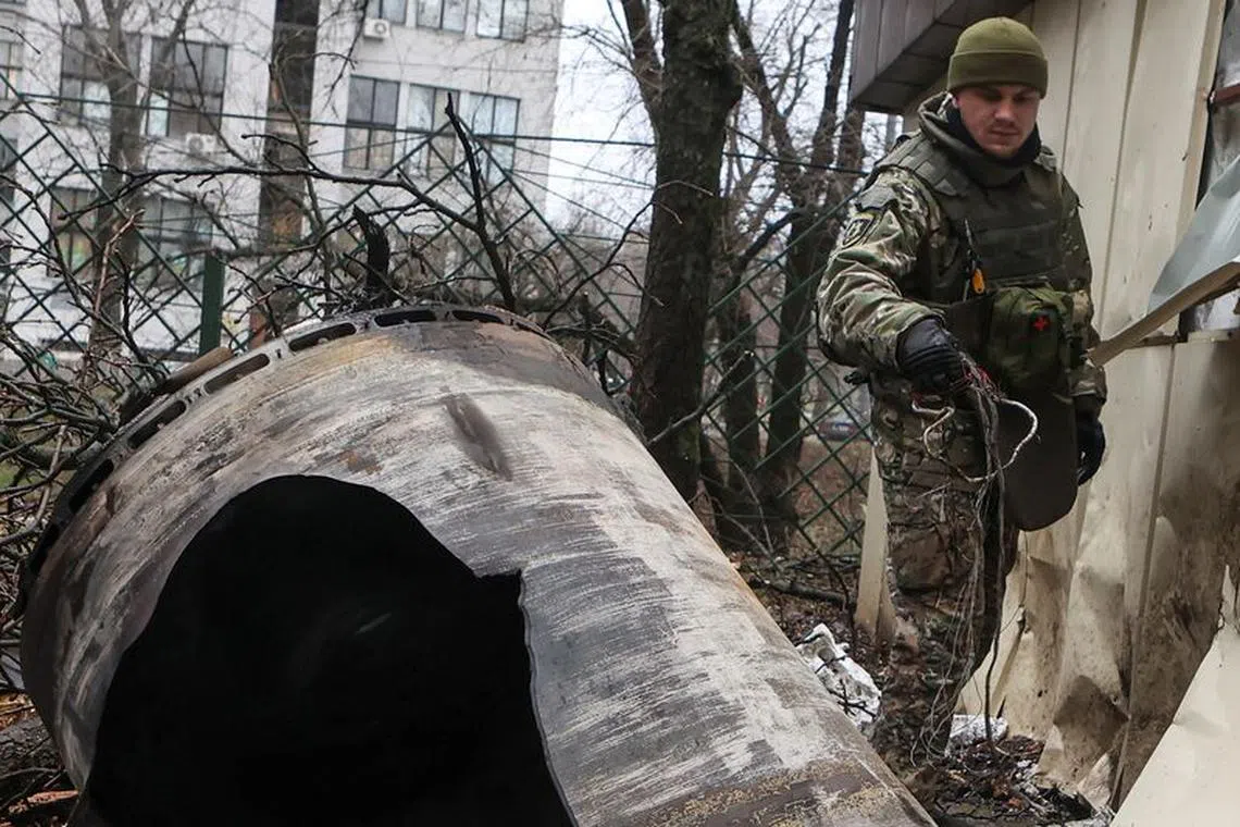 FILE PHOTO: A bomb squad member works next to remains of an unidentified missile at the site where residential buildings were heavily damaged during a Russian missile attack, amid Russia's attack on Ukraine, in central Kharkiv, Ukraine January 2, 2024. REUTERS/Sofiia Gatilova/File Photo