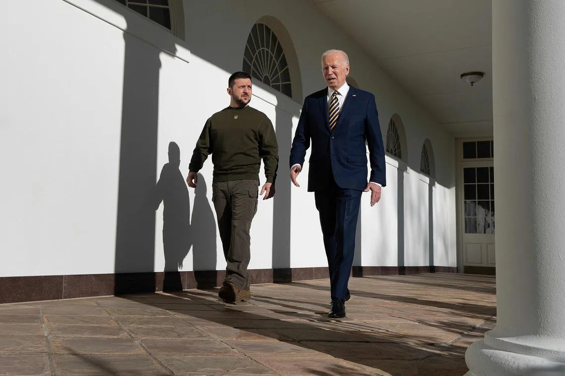 US President Joe Biden walks with Ukraine's President Volodymyr Zelensky through the colonnade of the White House, in Washington, DC, on Dec 21, 2022. 