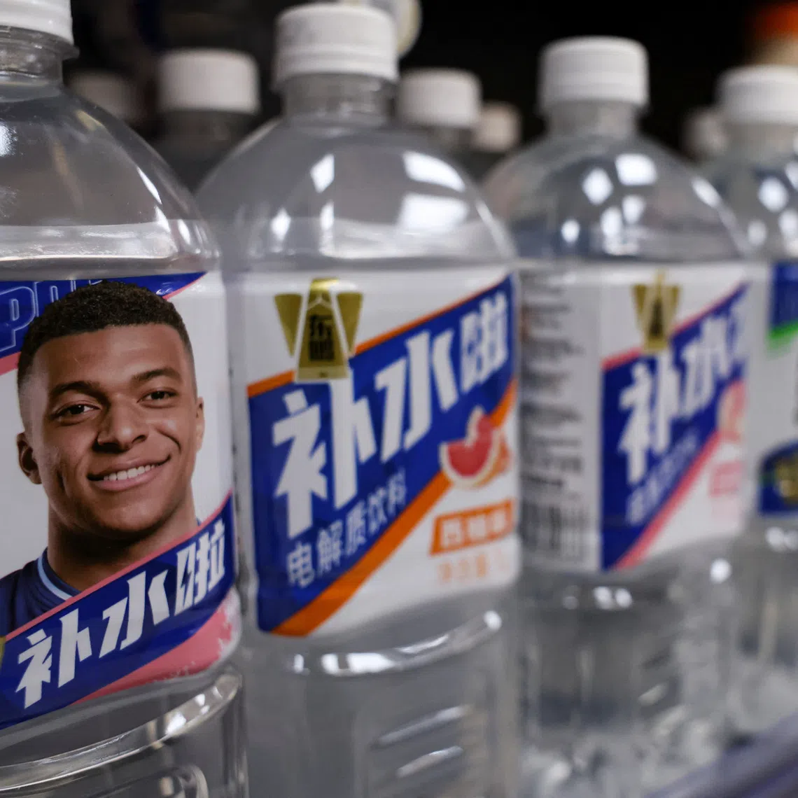 Bottled drinks by Eastroc Beverage with images of French soccer player Kylian Mbappe are displayed on a shelf at a store, in Beijing, China October 27, 2026. REUTERS/Tingshu Wang