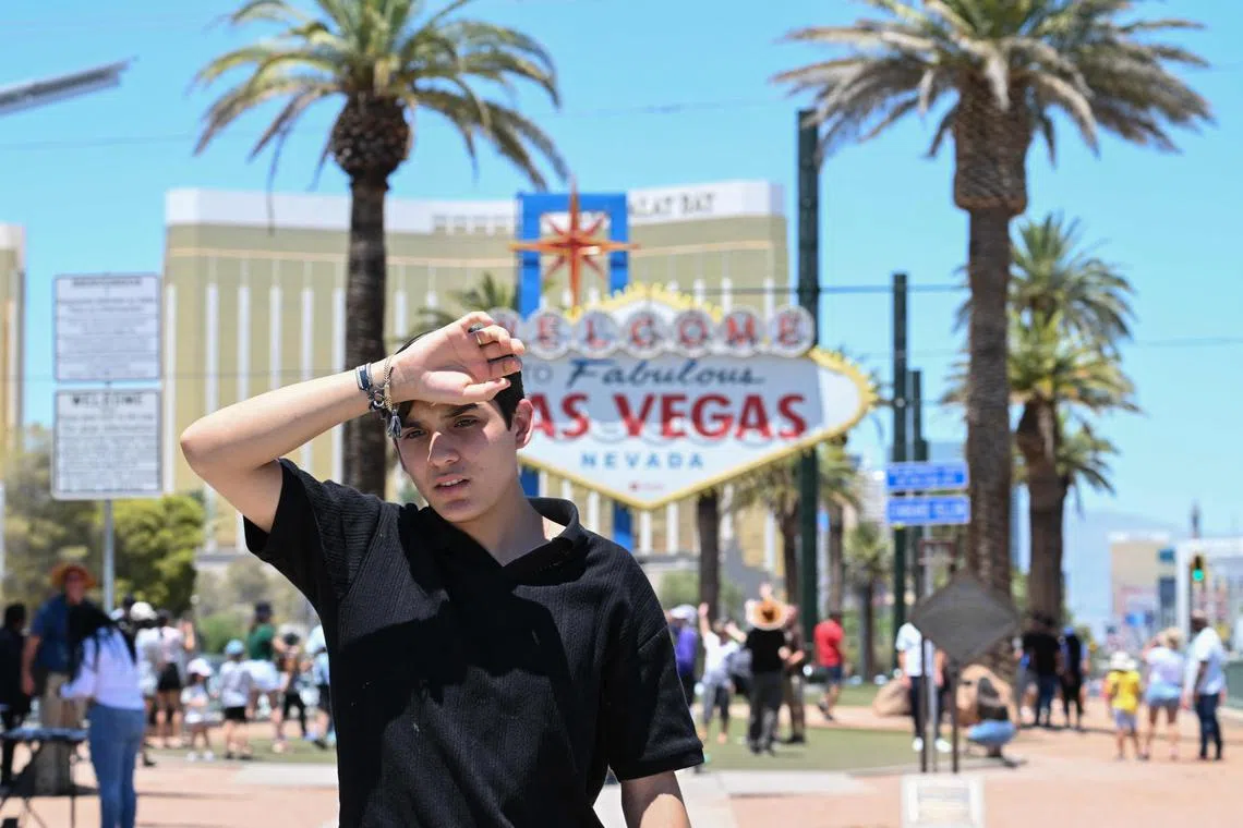 A man walks near the Las Vegas strip during a heatwave in Las Vegas, Nevada on July 7, 2024. According to the US National Weather Service, high temperatures in Las Vegas on Sunday could reach up to 117 degrees Farenheit (42 degrees Celsius). (Photo by Robyn Beck / AFP)